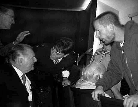 Demonstrators harangue Arthur Jensen while Walter Kistler tries to reason with them.